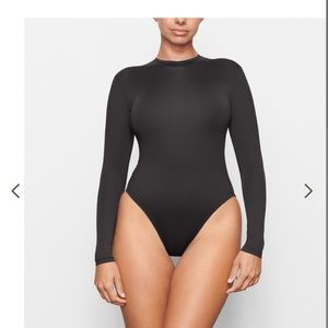 Skims swim  long sleeve 1 piece .